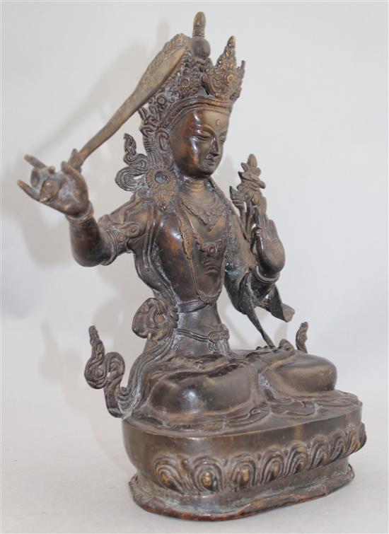 A Sino-Tibetan bronze seated figure of Manjushri, 31cm